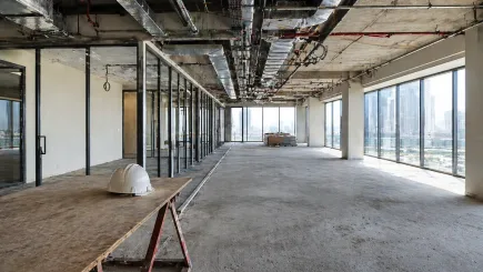 Open-plan UAE office fit-out in progress, with the division between completed and uncompleted areas representing the governance gap that forms when project decision accountability is unclear.