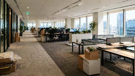 UAE open-plan office environment showing a workspace in transition, with active and vacant workstations representing an ongoing organisational change programme managed by an independent programme management consultancy.